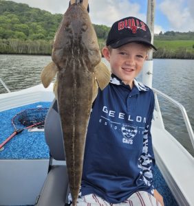 Louis with a nice Flathead caught deep water jigging on a Tweed River charter with Brad Smith